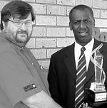 Rockwell Automation commercial marketing manager Abraham Brooks presenting SAMA president Dr Joe E. Amadi-Echendu with the new floating trophy